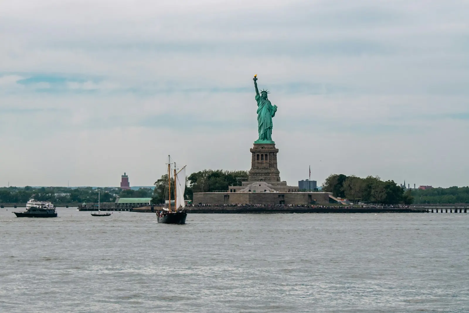 Statue of Liberty across New York Harbor: US immigration routes compared
